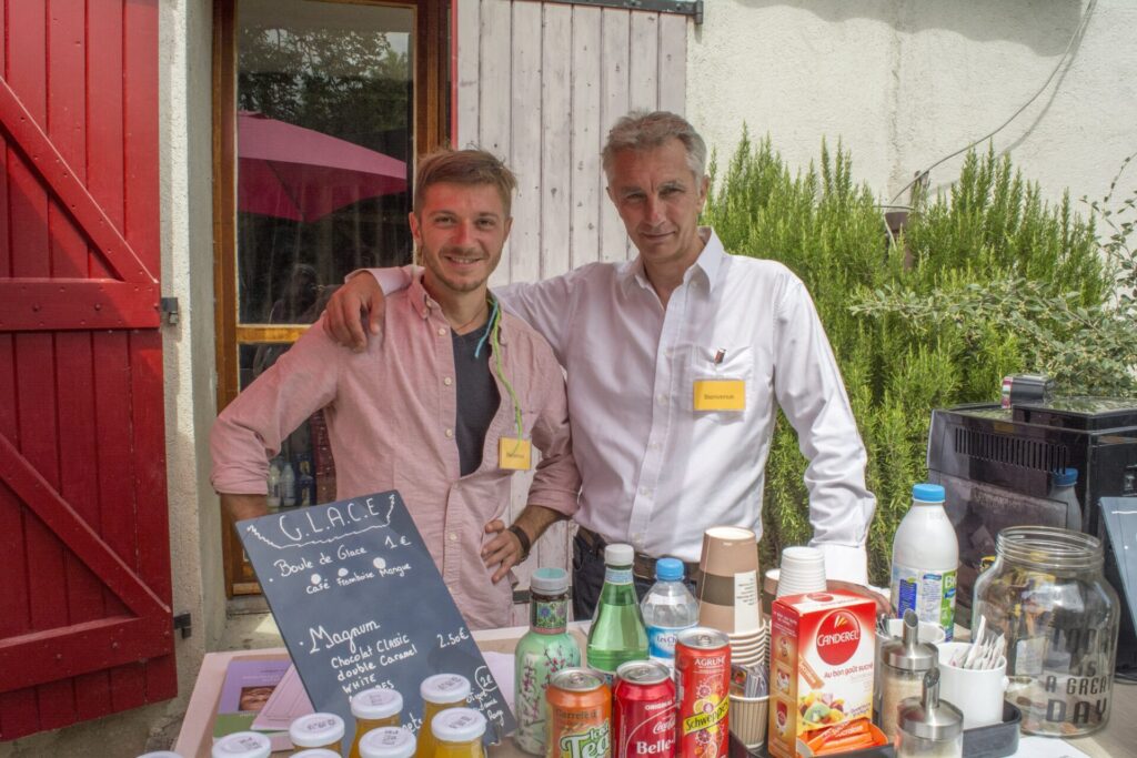 Two students serve coffee at Institut Vajra Yogini